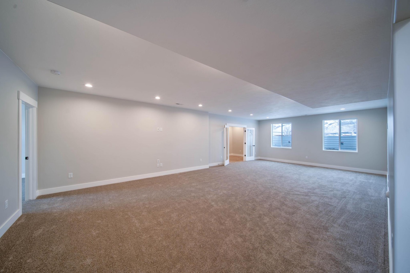 Finished basement living space with recessed lighting and luxury vinyl plank flooring