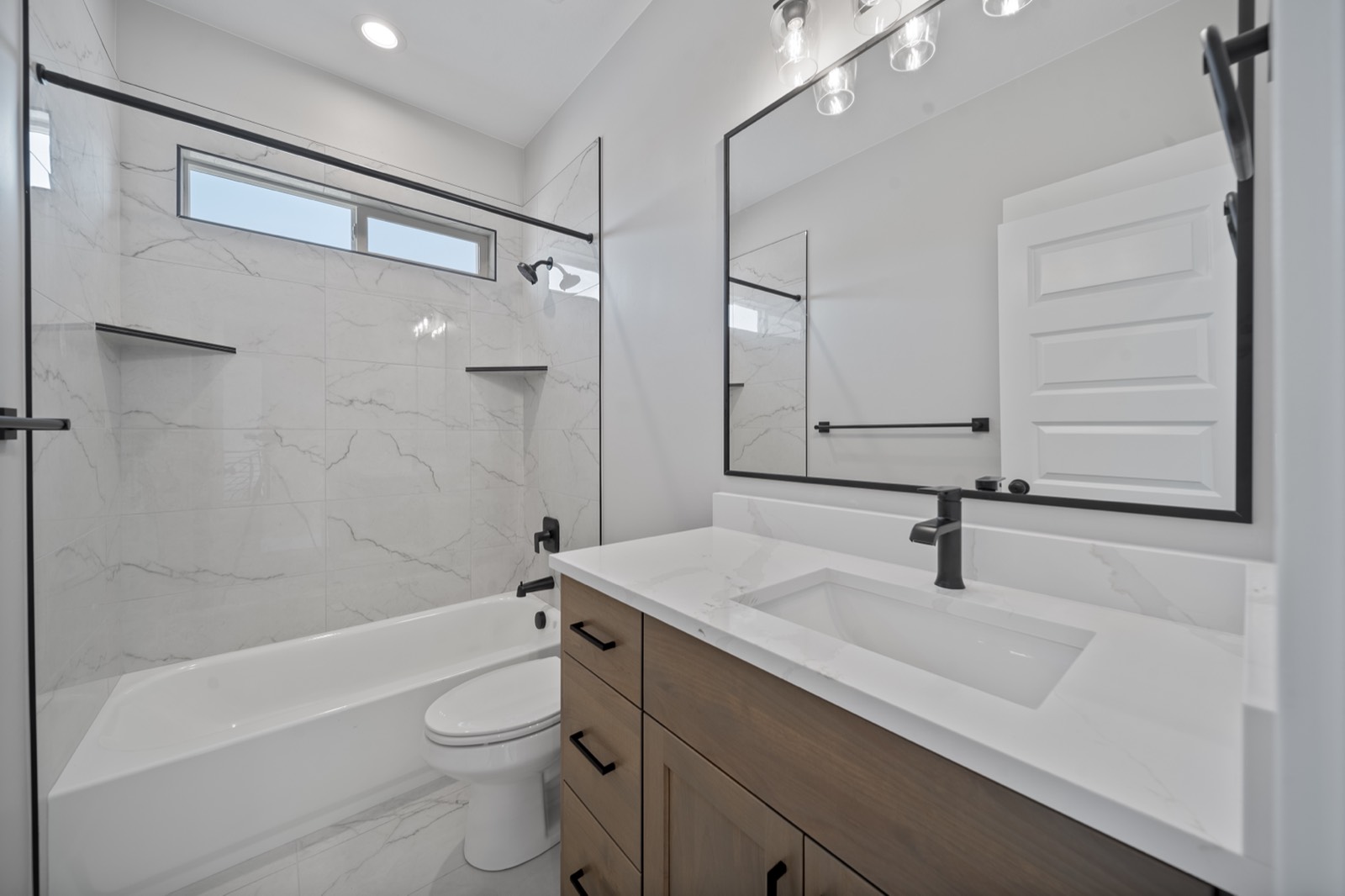 Bathroom vanity with quartz top and framed mirror