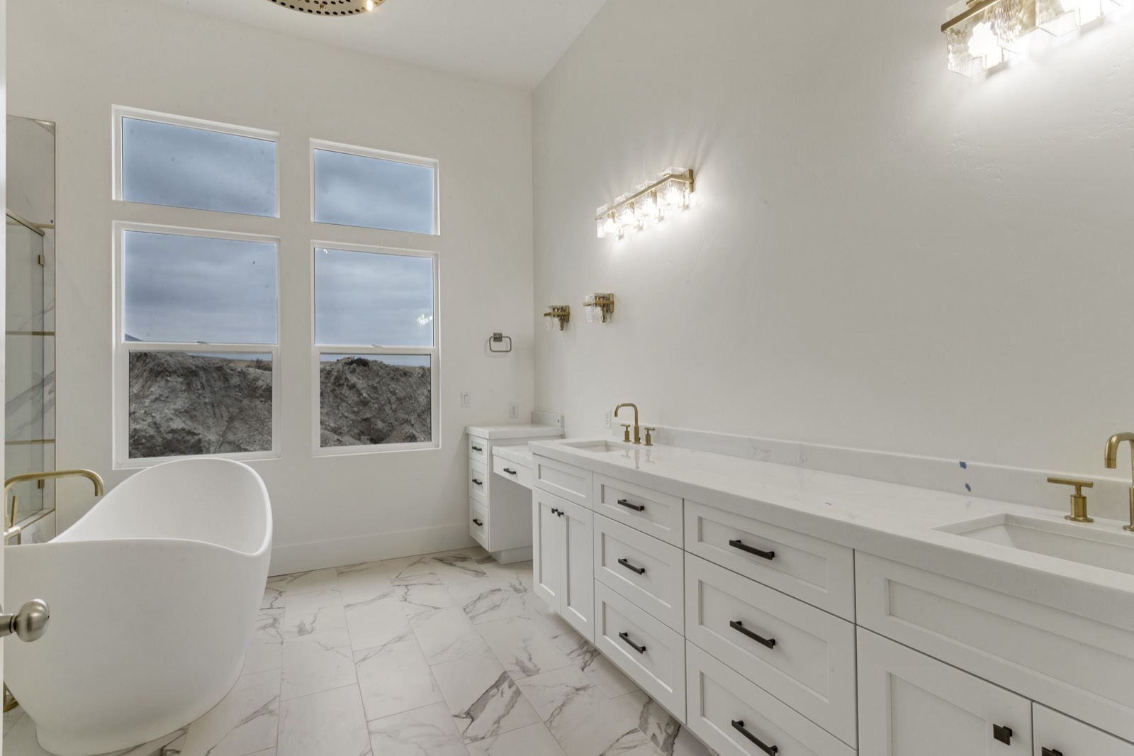 Primary bathroom with a large tiled shower and double vanity