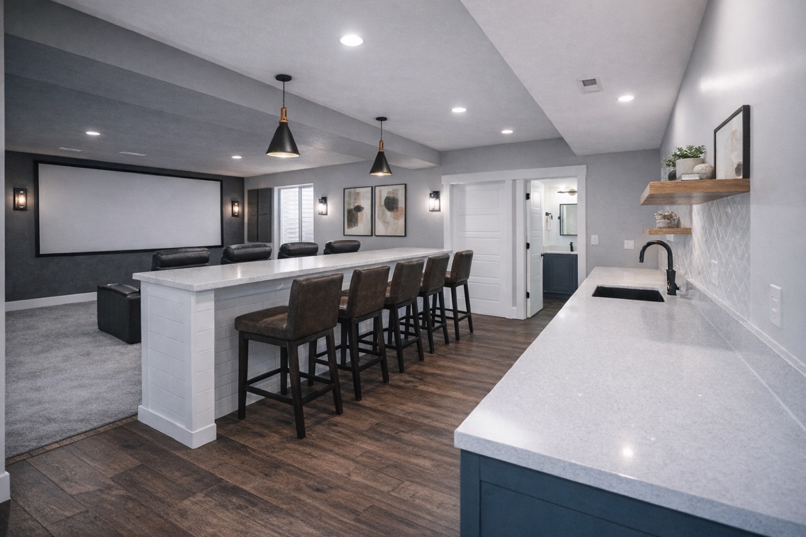 Finished basement with a kitchenette open to a home theater room